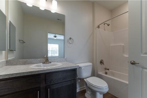 A bathroom with a white toilet and a white sink.