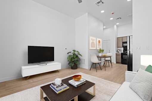 A modern living room with a flat screen TV on a white stand.