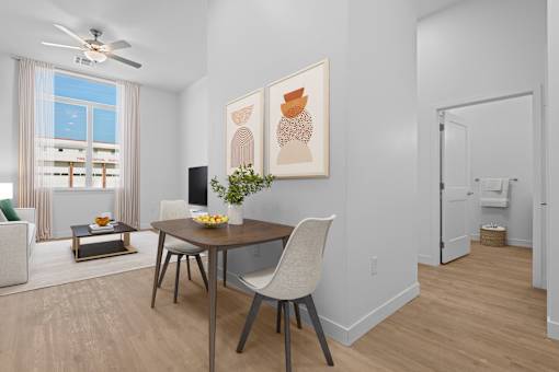 A dining room with a table and chairs.