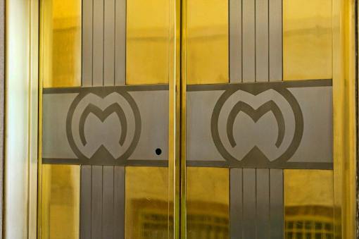A glass door with a heart-shaped design in the middle.