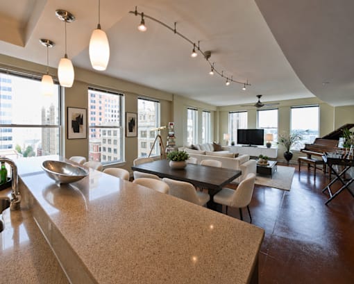 A modern kitchen with a large island and a dining area.