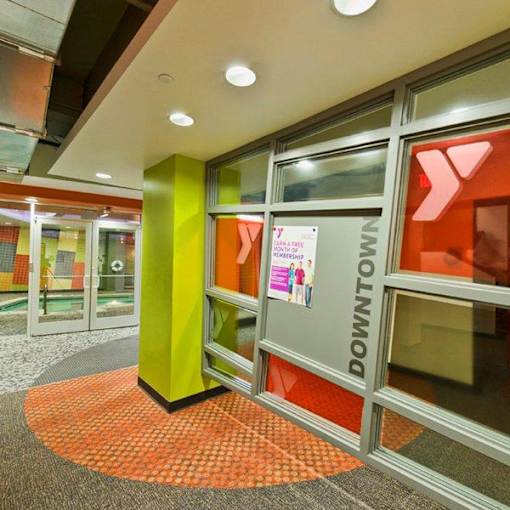 The image shows a glass door with a sign that reads "DOWNTOWN" on it.