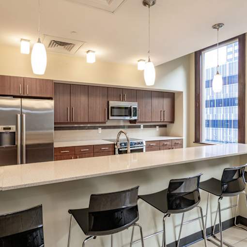 A kitchen with brown cabinets and a white counter.