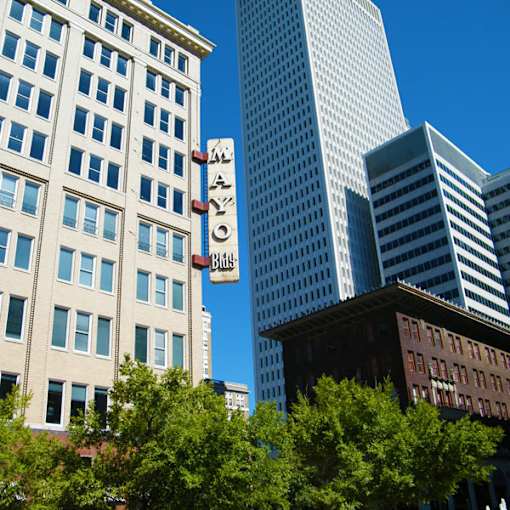A tall building with a sign that says "Mayo" in front of it.