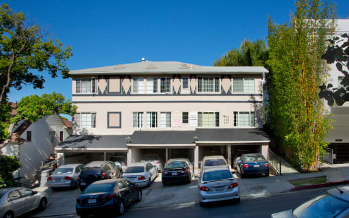 Exterior front view of an apartment building with parking spaces