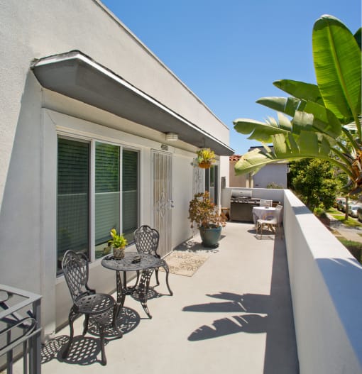 Apartment balcony with BBQ/grill and outdoor furniture