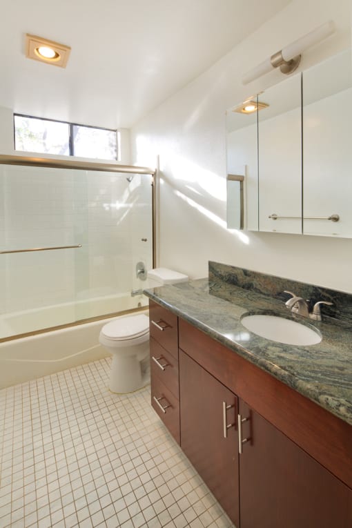 Apartment bathroom with vanity, shower tub combo