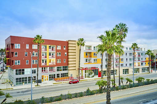 a row of colorful apartment buildings on the side of a street