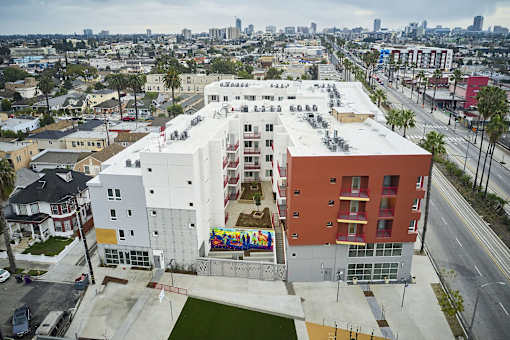 an aerial view of a building with a mural on the side of it