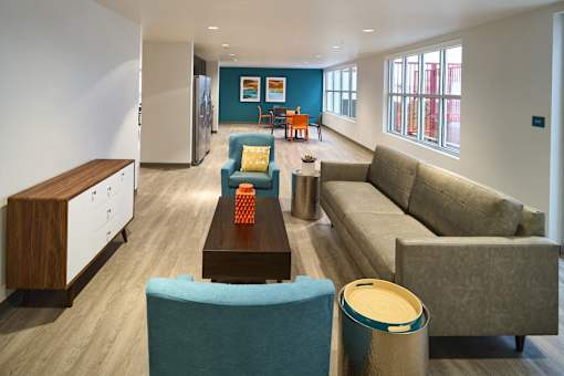 a living room with couches and chairs and a table