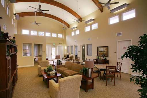 a large living room with couches and chairs and a table