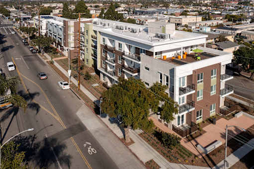 an aerial view of an apartment building on a city street