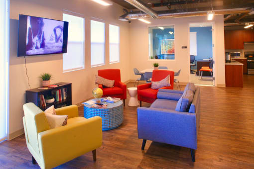 a living room with couches and chairs and a tv