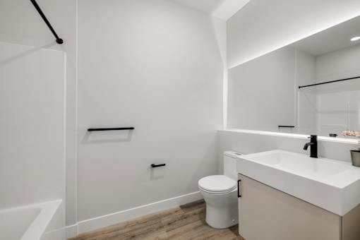 A white bathroom with a toilet and sink.