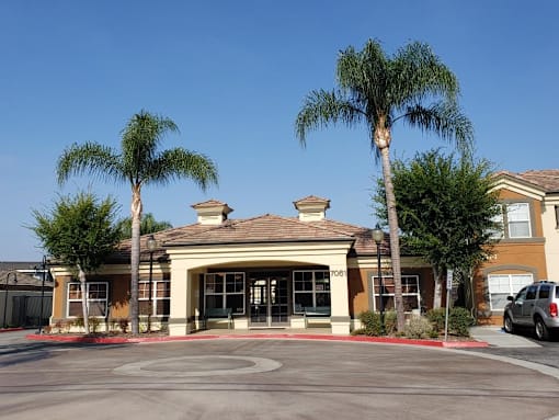 A building with palm trees in front of it.