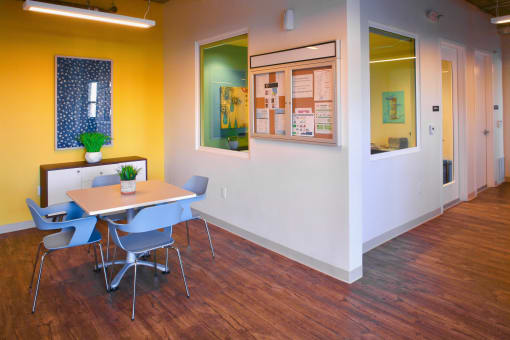a conference room with a table and chairs and a window