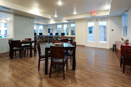 an empty dining room with tables and chairs in a building