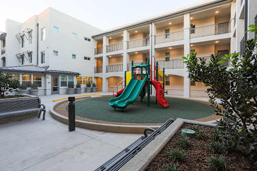 a playground at therium of a hotel with a colorful slide