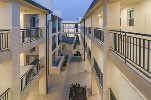 a view of a courtyard in a large apartment building