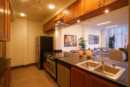 a kitchen with a sink and a stove and a refrigerator
