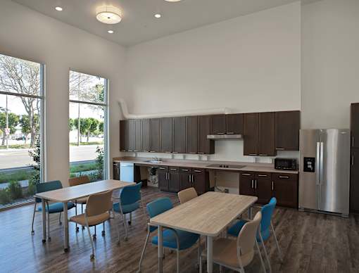 A modern kitchen with a dining table and chairs.