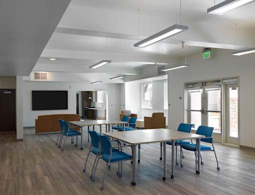 A conference room with a long table and chairs.
