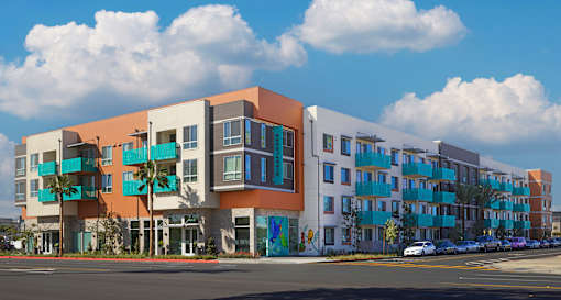 A modern apartment building with a mix of pastel and bold colors.