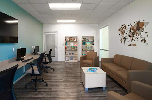 A modern office space with a world map on the wall.