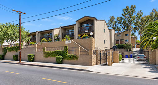 A street view of a residential area with houses and a car parked on the side.