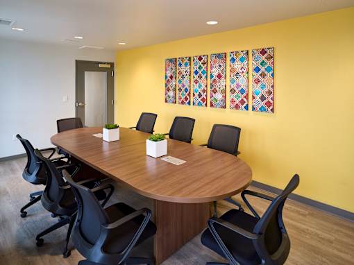 a conference room with a wooden table and chairs