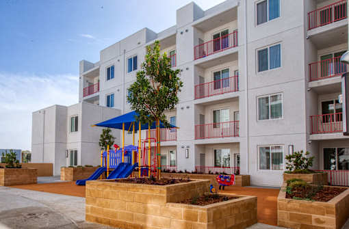 an apartment building with a playground in front of it