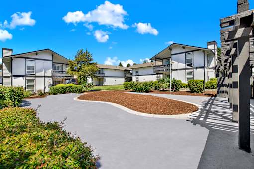 A residential area with houses and a curved driveway.