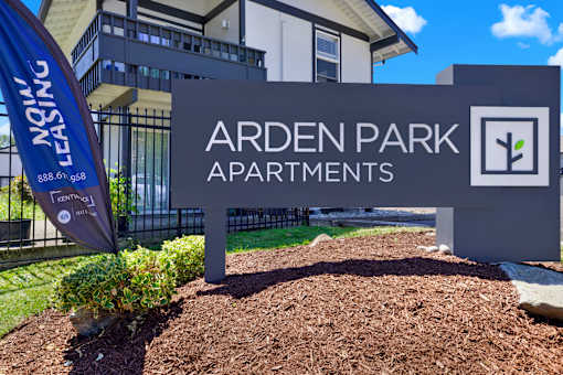 A sign for Arden Park Apartments is shown in front of a building.