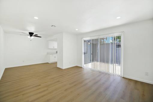 Open living area with kitchen and patio access at Coventry Square Apartments, Upland, 97186