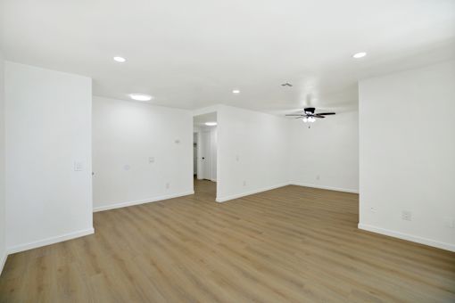 Spacious living room with wood style flooring at Coventry Square Apartments, Upland, California