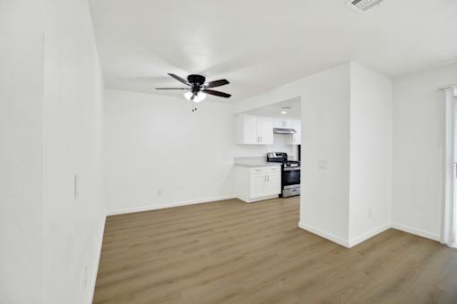 Open living and dining area with ceiling fan at Coventry Square Apartments, Upland