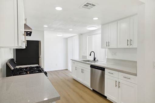 Modern kitchen with white cabinets and stainless appliances at Coventry Square Apartments, California, 97186