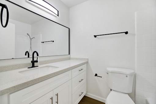 Bathroom with white vanity and subway tile shower at Coventry Square Apartments, California