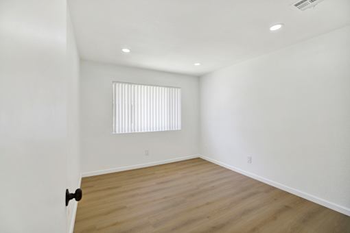 Empty bedroom with wood style flooring at Coventry Square Apartments, Upland, CA 97186