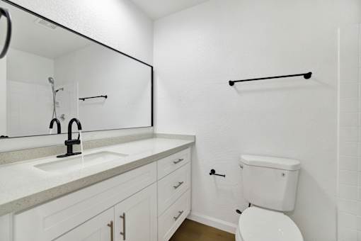 Modern bathroom with dual sink vanity and towel bar at Coventry Square Apartments, Upland, California
