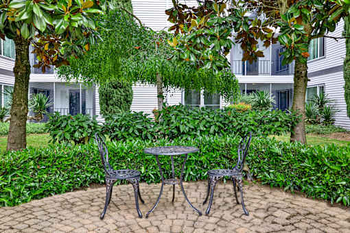 A patio with a table and two chairs.