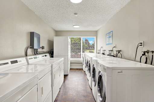 A laundry room with washers and dryers.