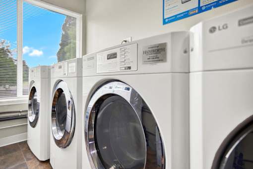 A row of LG front load washing machines are lined up in a store.