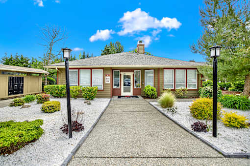 A house with a gravel driveway and a clear blue sky.