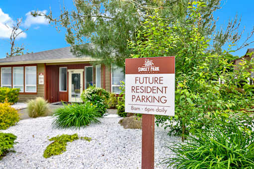 A sign in front of a house that says "Future Resident Parking 8am - 6pm daily".