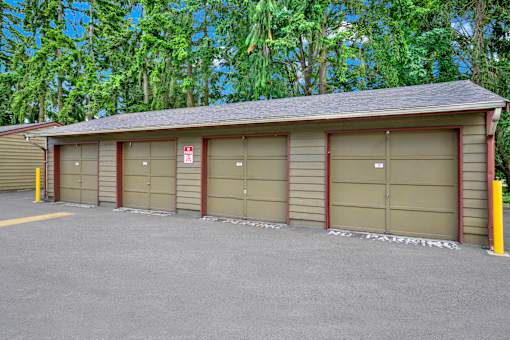 A building with a brown roof and a row of garage doors.