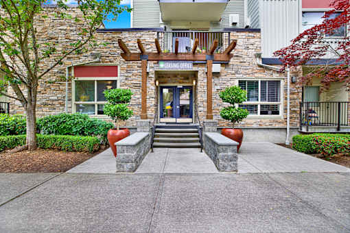A stone building with a wooden entrance and a glass door.