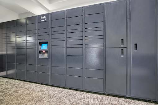 A row of dark grey lockers with a sign that says "hub" on the top left.