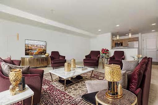 A living room with a large rug and a painting on the wall.