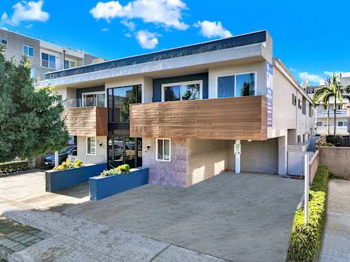 A modern two-story house with a balcony and a garage.at Federal Apartments, Los Angeles, CA 90025